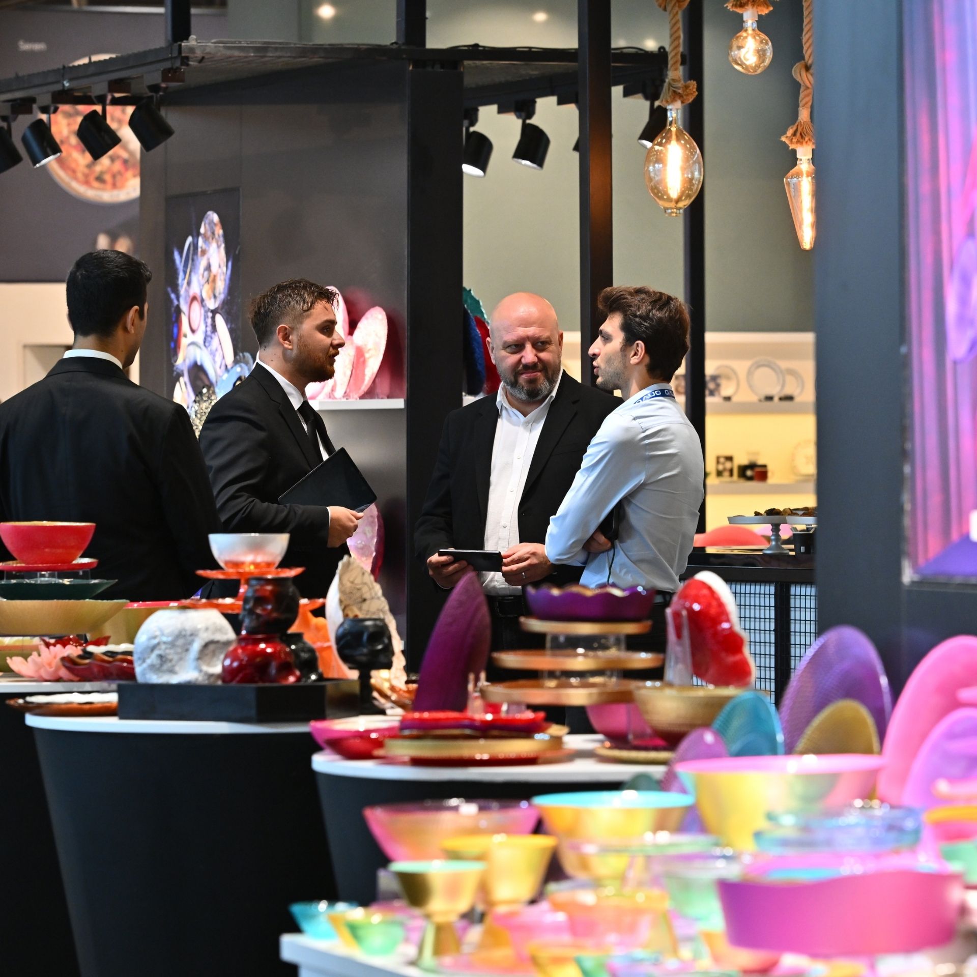 Business people are holding business meetings at the exhibitor's stand.