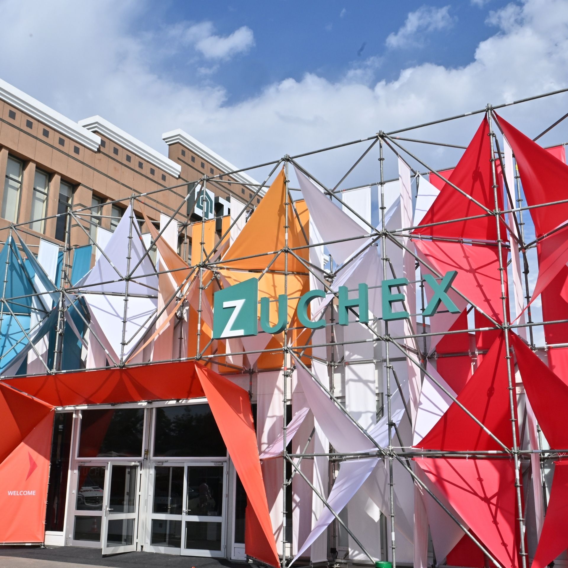Venue viewed from outside and ZUCHEX flags.