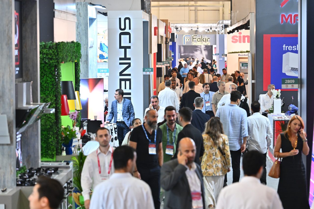 A moment captured from last year's Zuchex event, featuring visitors interacting with exhibitors and exploring various kitchenware items.