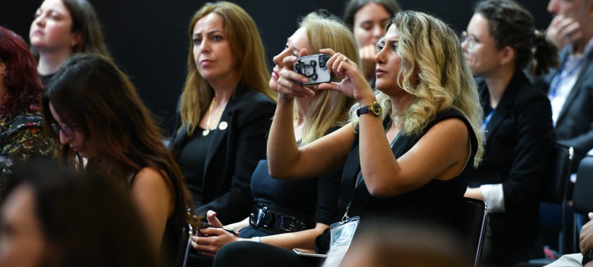 Visitors listens with interest and takes photos of the presentations